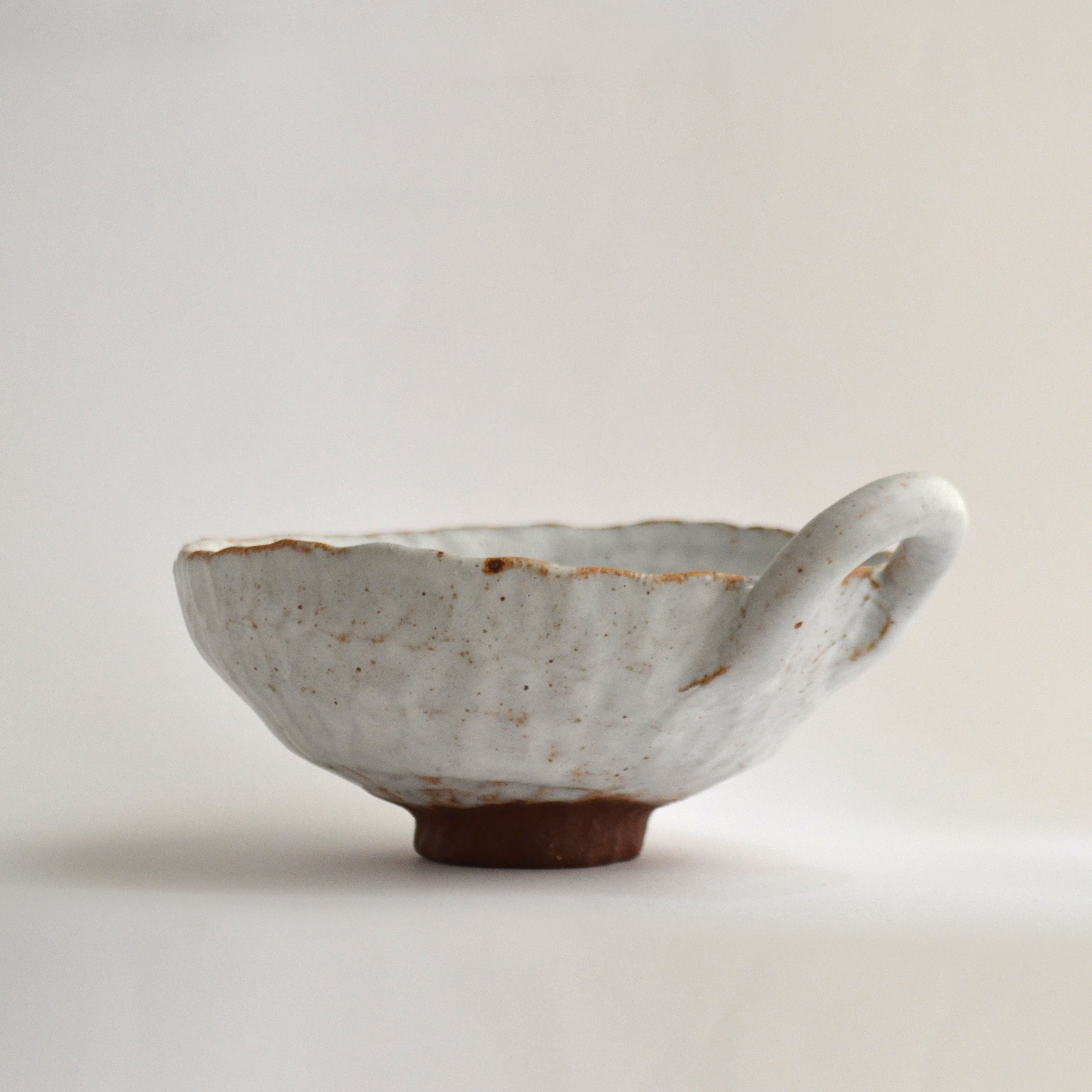 white stoneware handle cup